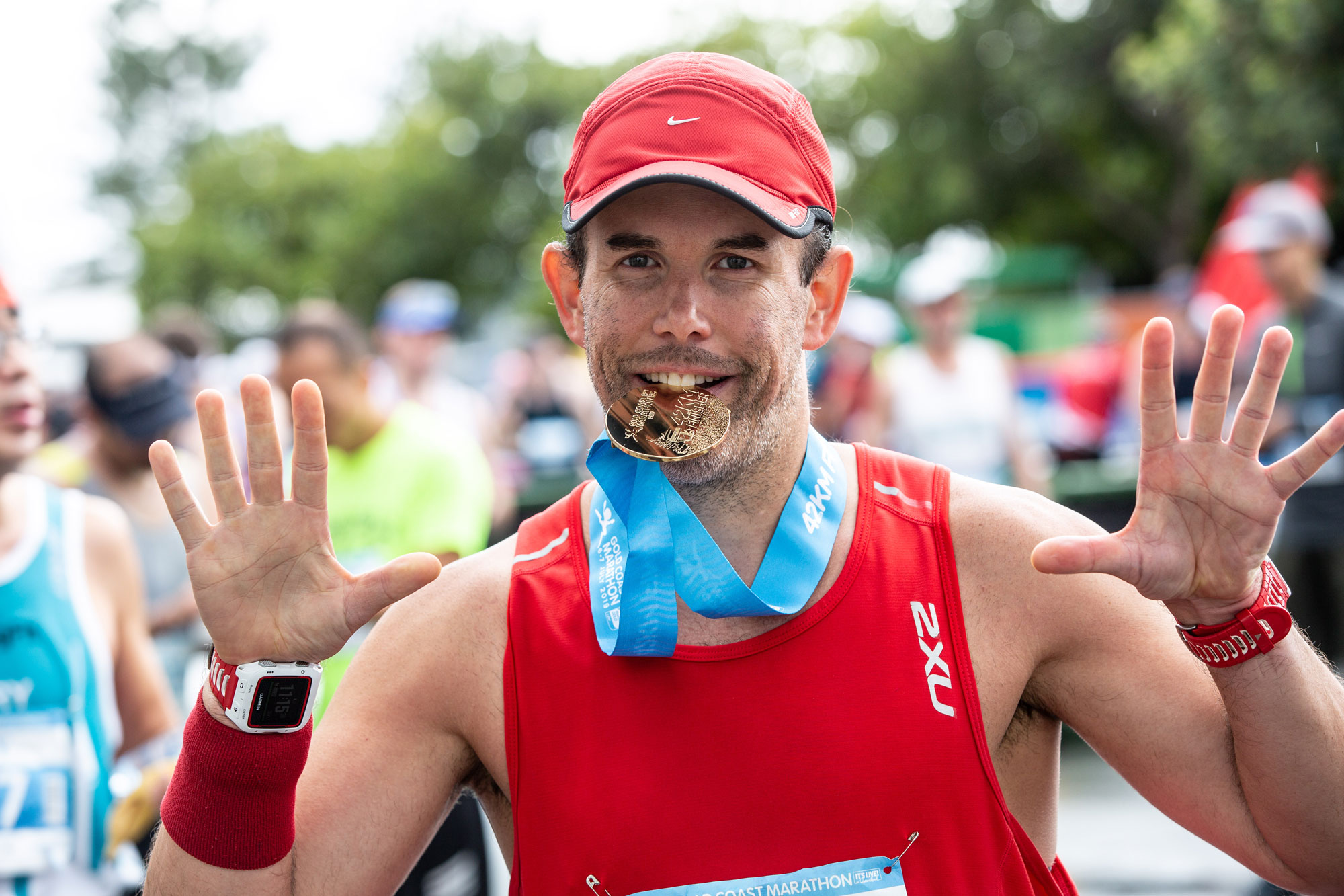 GCM19-Finisher-with-medal-in-mouth-optimised